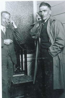Hokitika postmaster Ralph Cox with pioneer aviator Guy Menzies, notifying Menzies' parents of his arrival in New Zealand.