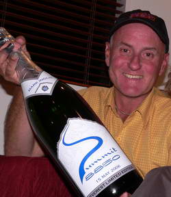 Mark Inglis smiles as he holds up a bottle of Summit 8850.