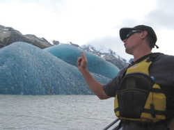 Operations Manager Bede Ward pointing out the features of the newly calved iceberg
