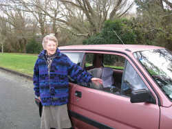 Audrey beside her car.