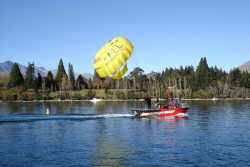 The photo taken on the steamship shows some tourists on a paraflight or parasail over Lake Wakatipu. It has gone up really high, too high for us.