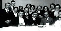 Guy Menzies at supper with Hokitika post-master Ralph Cox, the Cox family,and local dignitaries, Hokitika post office residence, 7/1/1931.