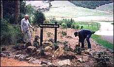 Earl and John Baird placing rocks at the entrance to the garden