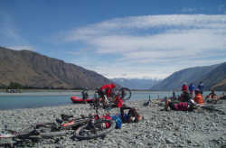 Cyclists having a rest at the raft crossing of the Rangitata River