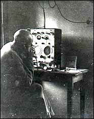 Jim Chaffey tunes in at 6.55 a.m. for  a staff briefing.  Photo
taken about 1954