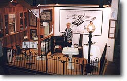 Margaret Palmer beside a museum display area